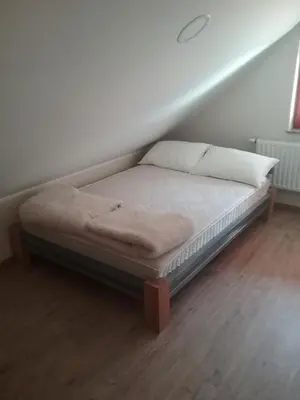 a bed in the corner of a room at Hudinja 111 in Vitanje