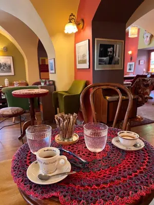 a table with cups and saucers on top at MuziKafe - Home of Culture in Ptuj