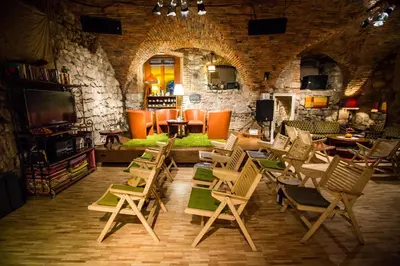 a room with a bunch of chairs and tables at MuziKafe - Home of Culture in Ptuj