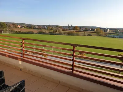 a bench with a view of a soccer field at Apartmaji PANONIA 