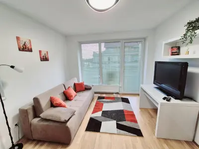a living room with a couch and a flat screen tv at Apartmaji PANONIA 