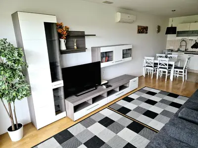 a living room with a tv and a couch at Apartmaji PANONIA 