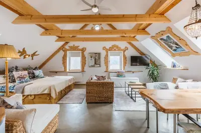 a living room with two beds and a table at Guesthouse Sabine - pr` Skminc in Bohinjska Bela