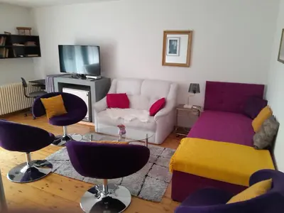 a living room with a couch and chairs at Aparthouse Ani in Radovljica