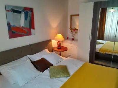a bedroom with a bed and a table with a lamp at Aparthouse Ani in Radovljica