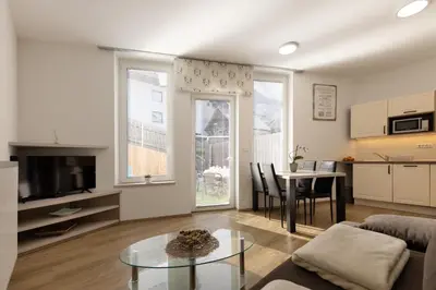 a living room with a couch and a table at Apartmaji 