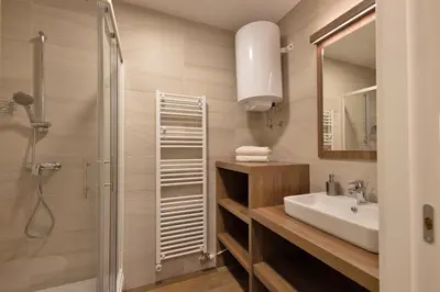 a bathroom with a sink and a shower at Apartmaji 