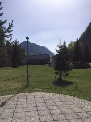 a street light in a field with a fence at Apartma Pika in Mojstrana