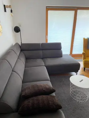 a living room with a couch and a table at Apartma Pika in Mojstrana