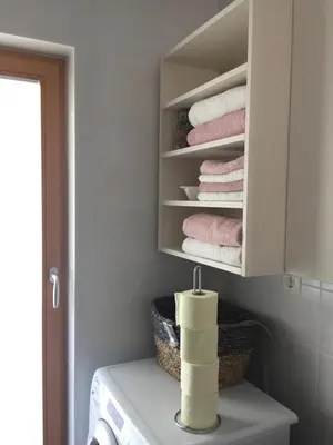 a laundry room with towels in a white cabinet at Apartma Pika in Mojstrana