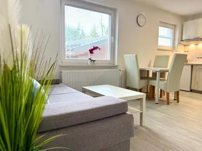 a living room with a couch and a table at Guest house Kobal in Spodnje Gorje