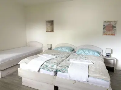 a bedroom with two beds and two night stands at Guest house Kobal in Spodnje Gorje