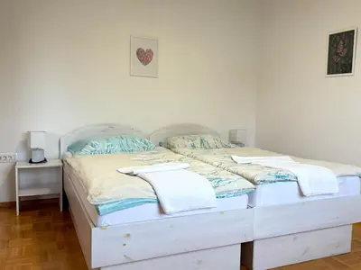 a bedroom with two twin beds with towels on them at Guest house Kobal in Spodnje Gorje