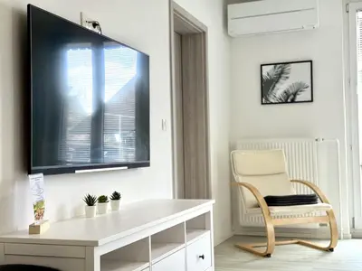 a living room with a flat screen tv on a wall at Guest house Kobal in Spodnje Gorje