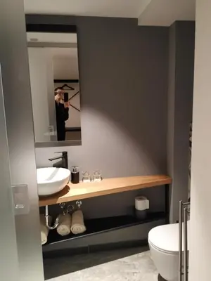 a person taking a picture of a bathroom with a mirror at B & W KRIŽ in Ajdovščina