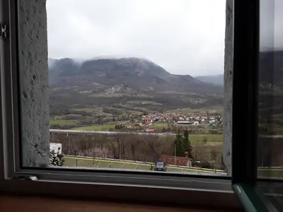 a view of a mountain from a window at B & W KRIŽ in Ajdovščina