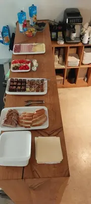 a long wooden table with plates of food on it at B & W KRIŽ in Ajdovščina