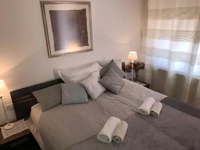 a bedroom with a bed with two towels on it at Klinar - Cosy apartment with a terrace in Bled