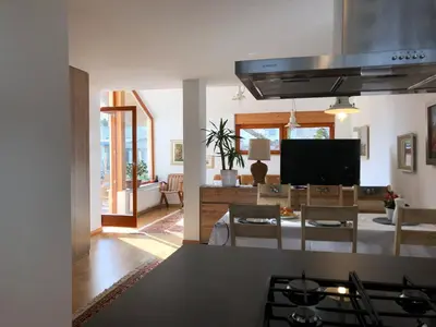 a kitchen and living room with a stove top oven at Klinar - Cosy apartment with a terrace in Bled