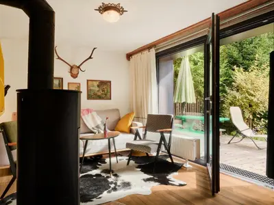 a living room with a large sliding glass door at Idyllic cottage in beautiful Alps in Zgornje Jezersko