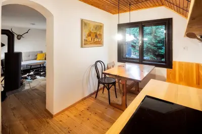 a kitchen with a table and a dining room at Idyllic cottage in beautiful Alps in Zgornje Jezersko