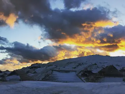 a cloudy sky with a mountain in the snow at Chalet Gasparjeva Velika Planina in Kamnik