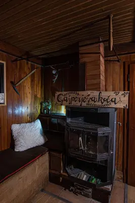 a room with a stove and a bed in a cabin at Chalet Gasparjeva Velika Planina in Kamnik