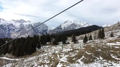 a ski slope with trees and snow covered mountains at Chalet Gasparjeva Velika Planina in Kamnik