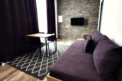 a living room with a couch and a table at Apartments The Art House in Škofljica