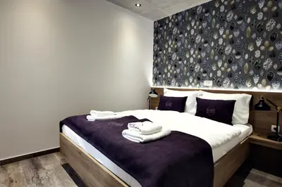 a bedroom with a bed with towels on it at Apartments The Art House in Škofljica