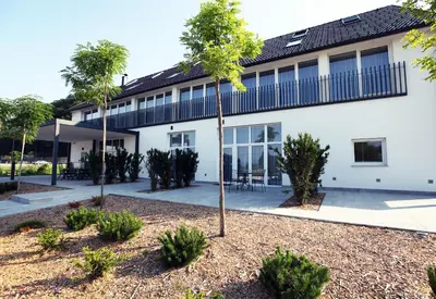 a building with trees in front of it at Apartments The Art House in Škofljica