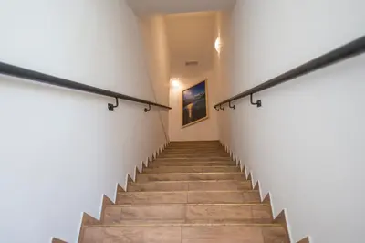 a staircase in a building with white walls and wooden floors at Apartmaji Štrud´l Bohinj in Bohinj