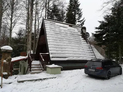 a car parked in front of a house in the snow at KOČA PLANIKA, SVIŠČAKI in Ilirska Bistrica