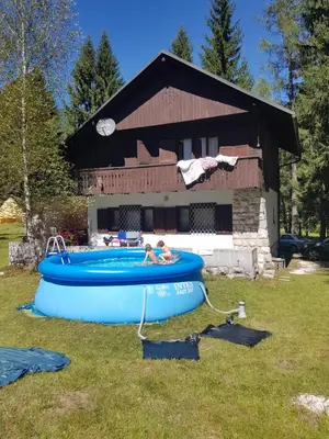two people in a blue inflatablelatable at Vila Krpan Kranjska Gora in Gozd Martuljek