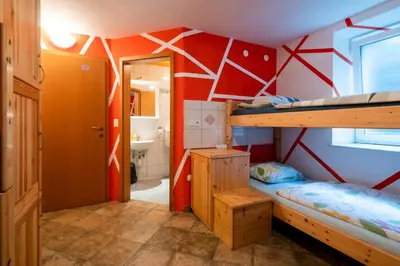 a room with two bunk beds and a bathroom at Bled Hostel in Bled