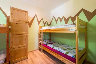 a bedroom with two bunk beds in a room at Bled Hostel in Bled