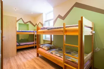a bunk room with three bunk beds in it at Bled Hostel in Bled