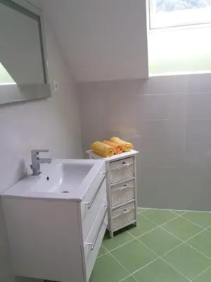 a white bathroom with a sink and a mirror at Apartma Momo in Bohinj