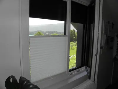 a window with a view of a mountain at Island View Apartment in Bled
