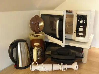 a shelf with a coffee maker and a microwave at Island View Apartment in Bled