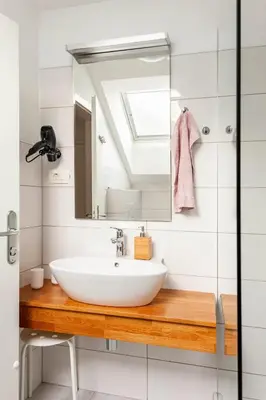 a bathroom with a sink and a mirror at Island View Apartment in Bled