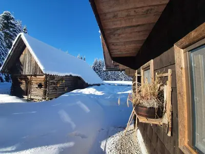 a yard covered in snow next to a house at Zalin planinski raj in Goreljek