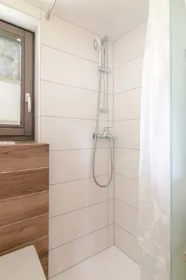a shower with a glass door in a bathroom at Zalin planinski raj in Goreljek