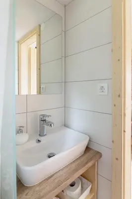 a white bathroom with a sink and a mirror at Zalin planinski raj in Goreljek