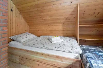 a room with a bed in a wooden cabin at Zalin planinski raj in Goreljek