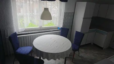 a table and chairs in a room with a window at APARTMENT PRIMČEVA in Maribor