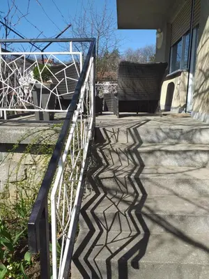 a stairway with a white rail and a chair on it at APARTMENT PRIMČEVA in Maribor