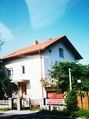 a large white house with a red roof at APARTMENT PRIMČEVA in Maribor