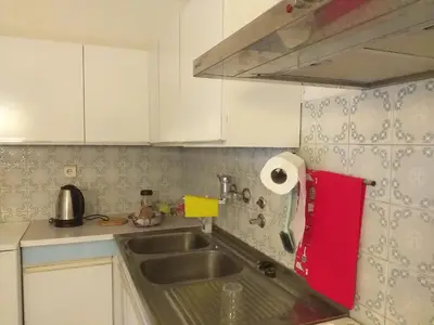a kitchen with a sink and a red towel at APARTMENT PRIMČEVA in Maribor