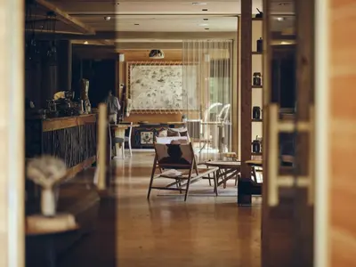 a living room with chairs and a dining room at Boutique hotel Vila Planinka in Zgornje Jezersko